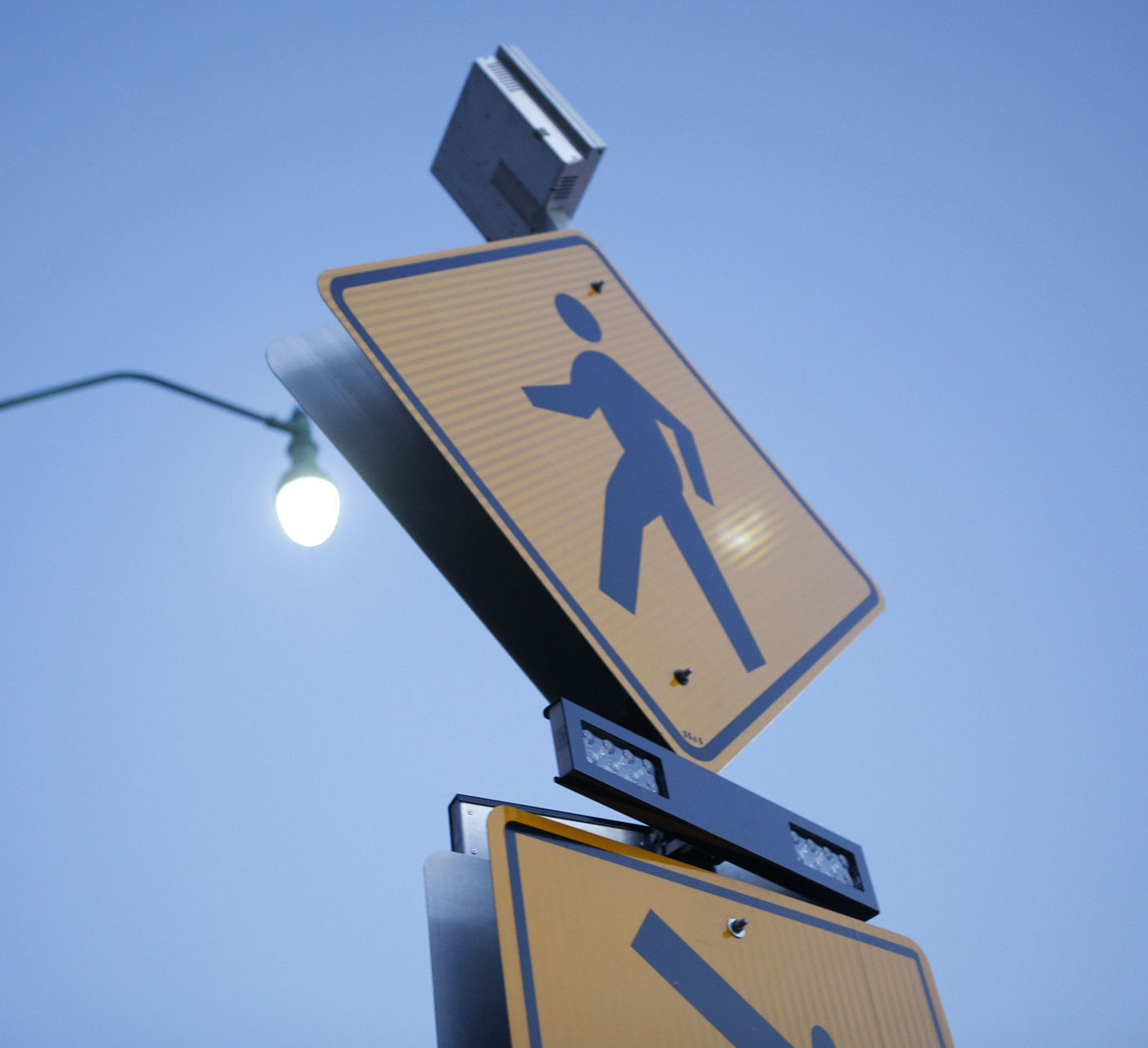 Closeup view of solar-powered crosswalk traffic beacon with rectangular rapid flashing beacons