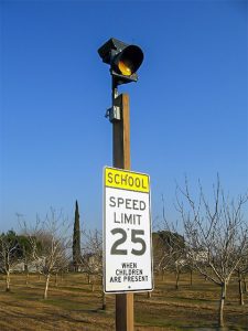 carmanah school zone speed sign beacon on wood post