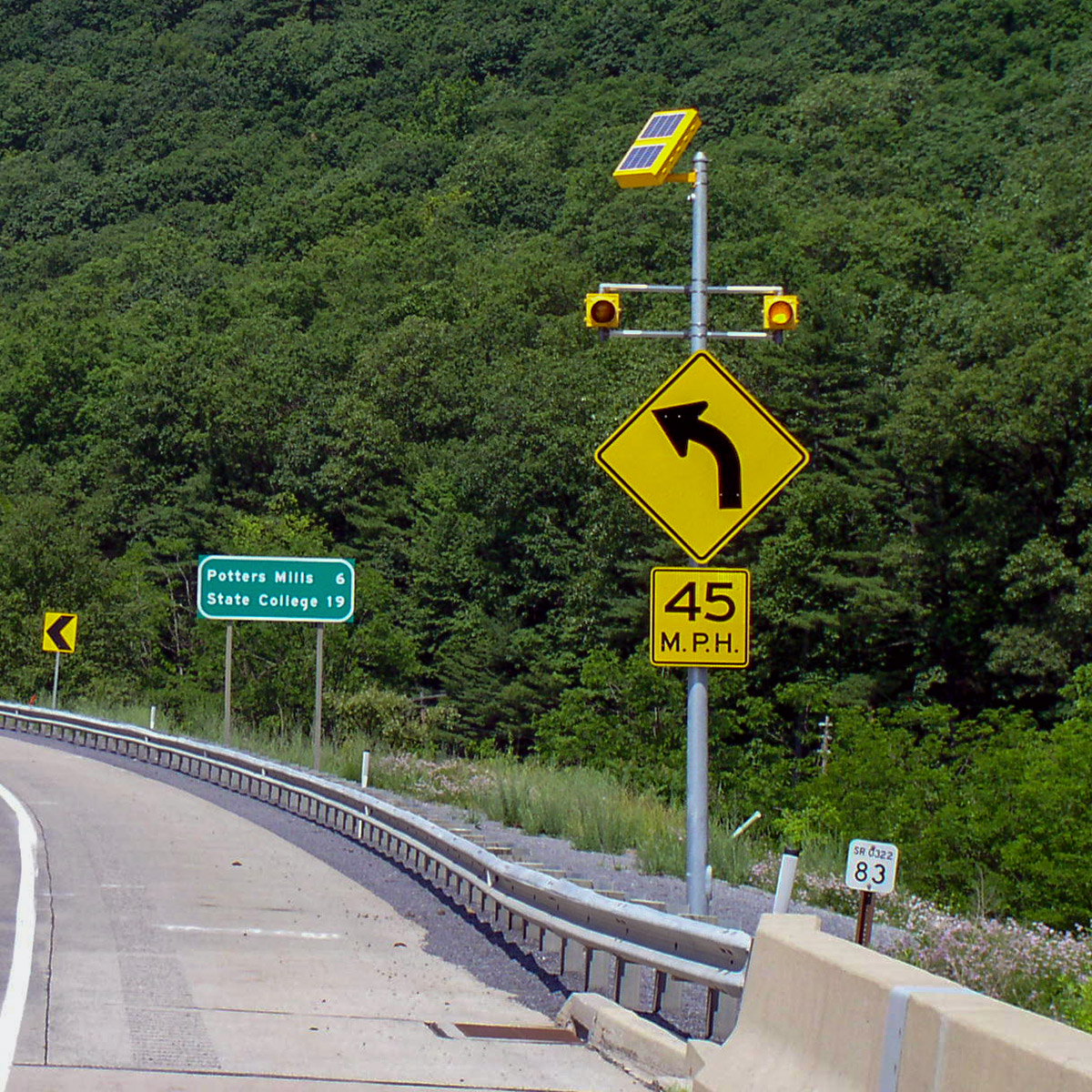 solar-powered warning sign flashing beacon on highway sign