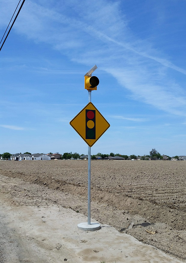 Solar-powered intersection ahead warning sign flashing beacon