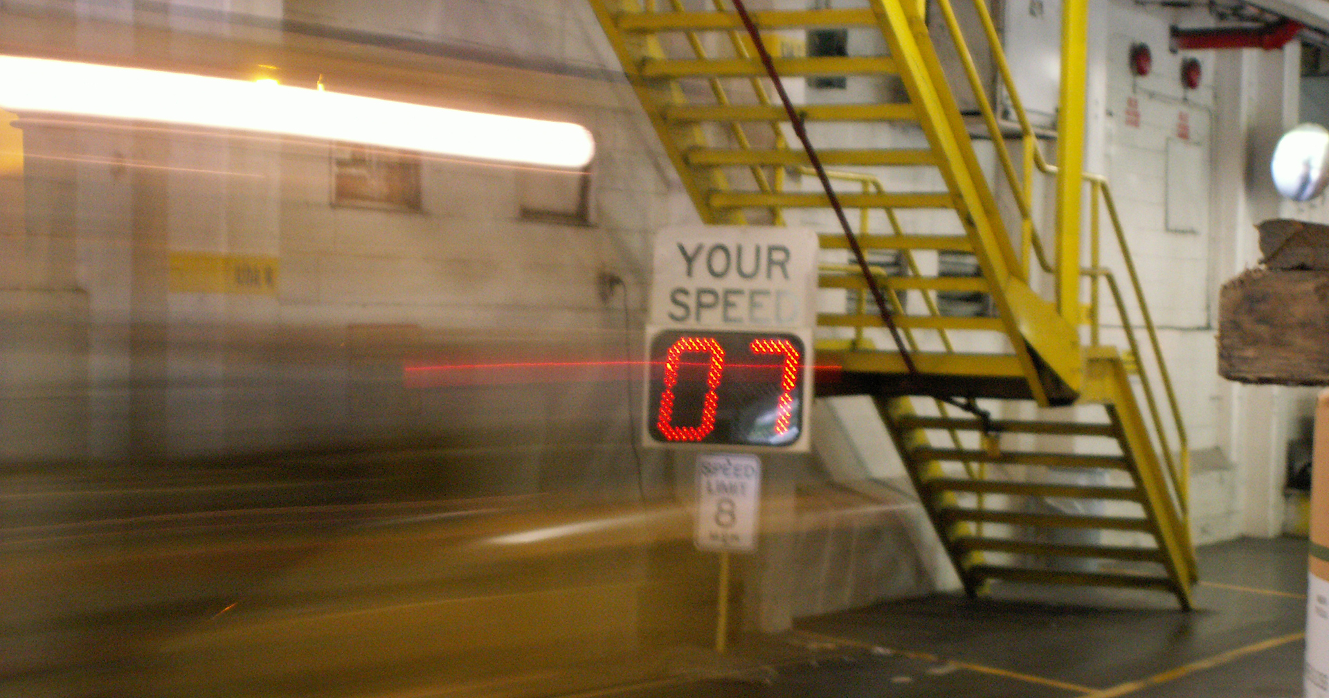 Warehouse with a your speed sign and speed limit sign