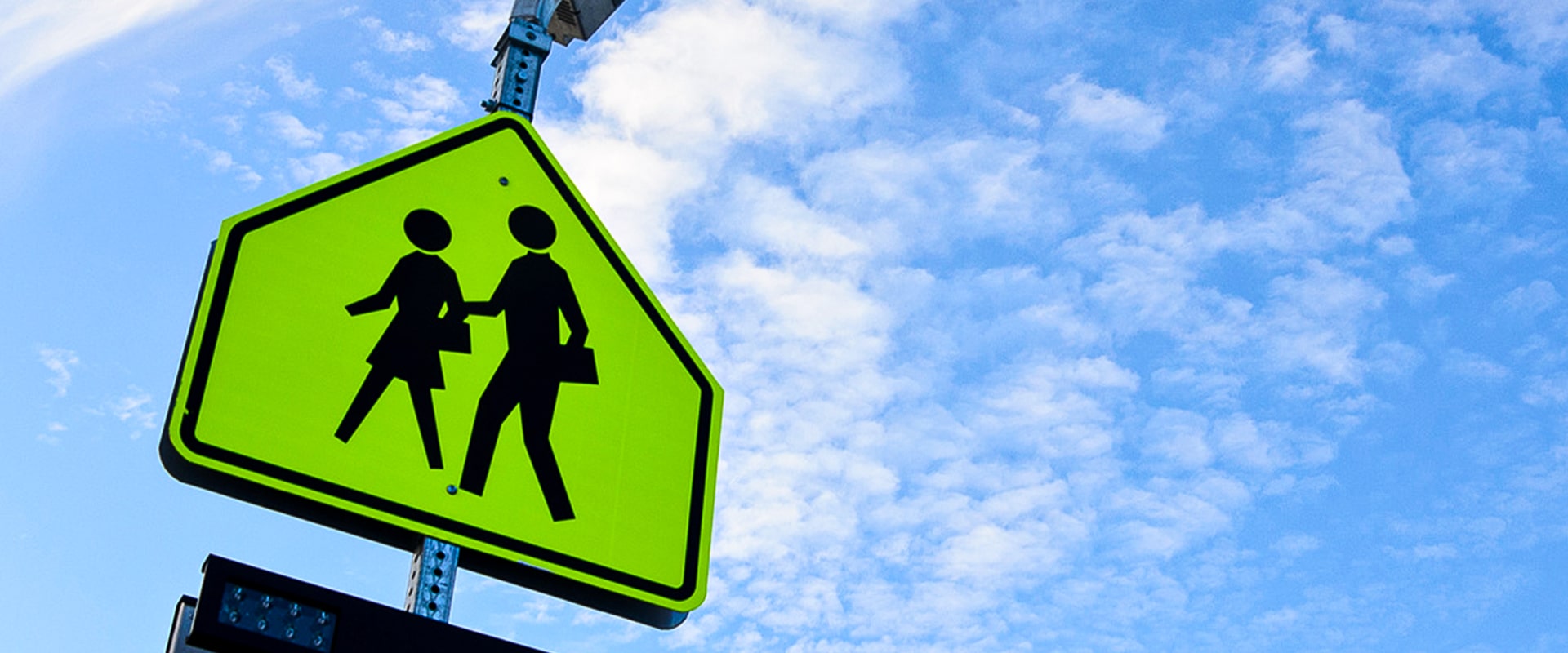 fluorescent yellow green school zone sign with a solar powered rectangular rapid flashing beacon