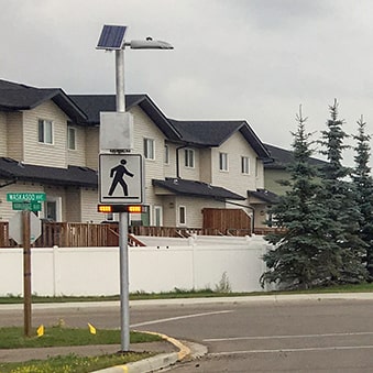 Penhold AB Waskasoo and Hawkridge RRFB crosswalk with overhead lighting close-up