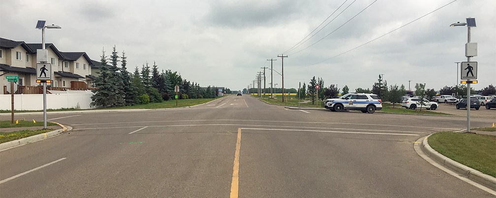Penhold AB Waskasoo and Hawkridge RRFB crosswalk with overhead lighting wide view