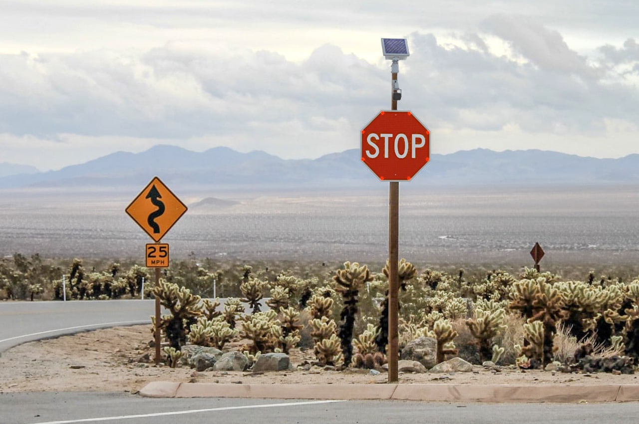 rural cross road with vehicle-activated intersection warning conflict system stop sign
