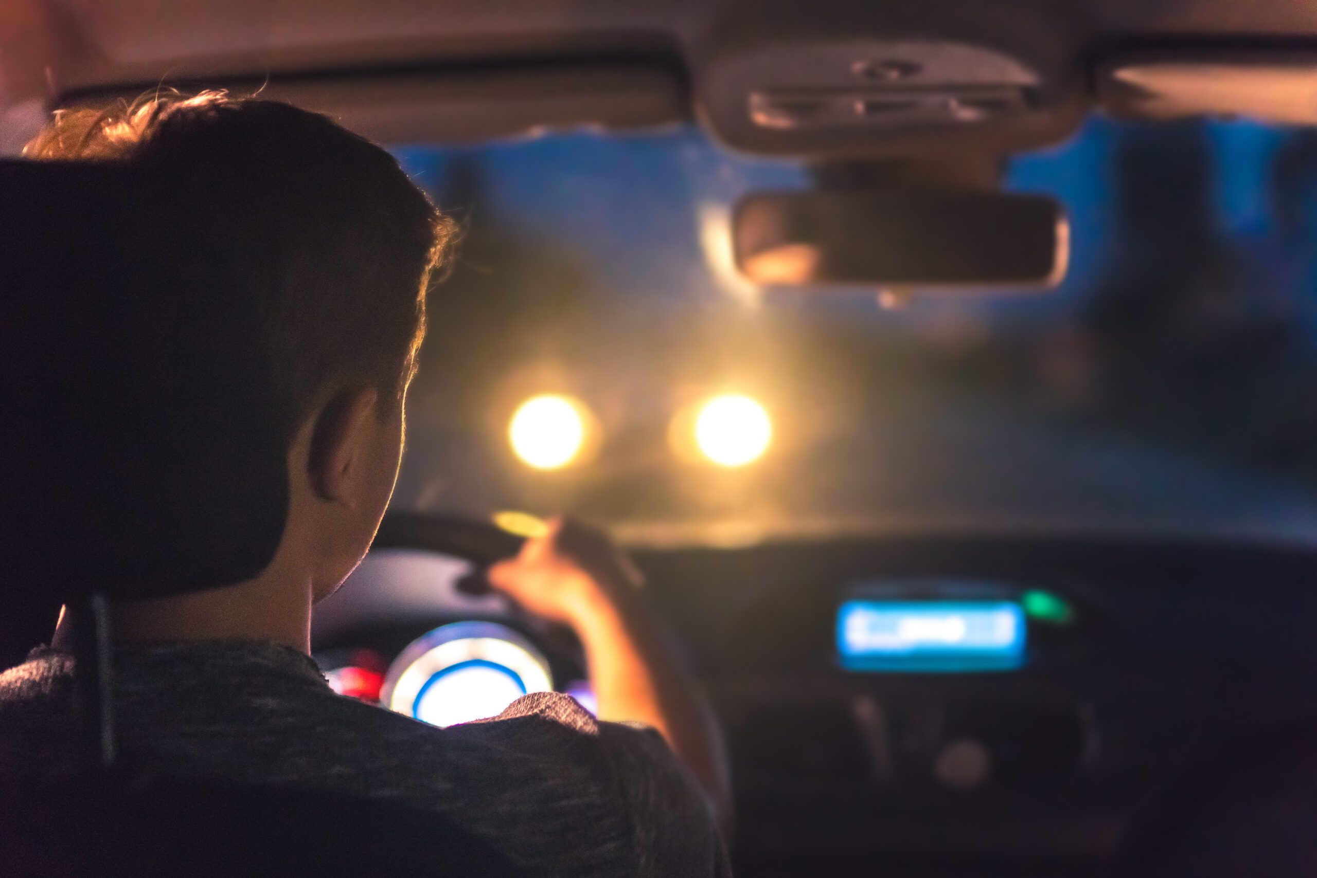 A man driving a car at night with wrong-way driver approaching - WW400 Florida